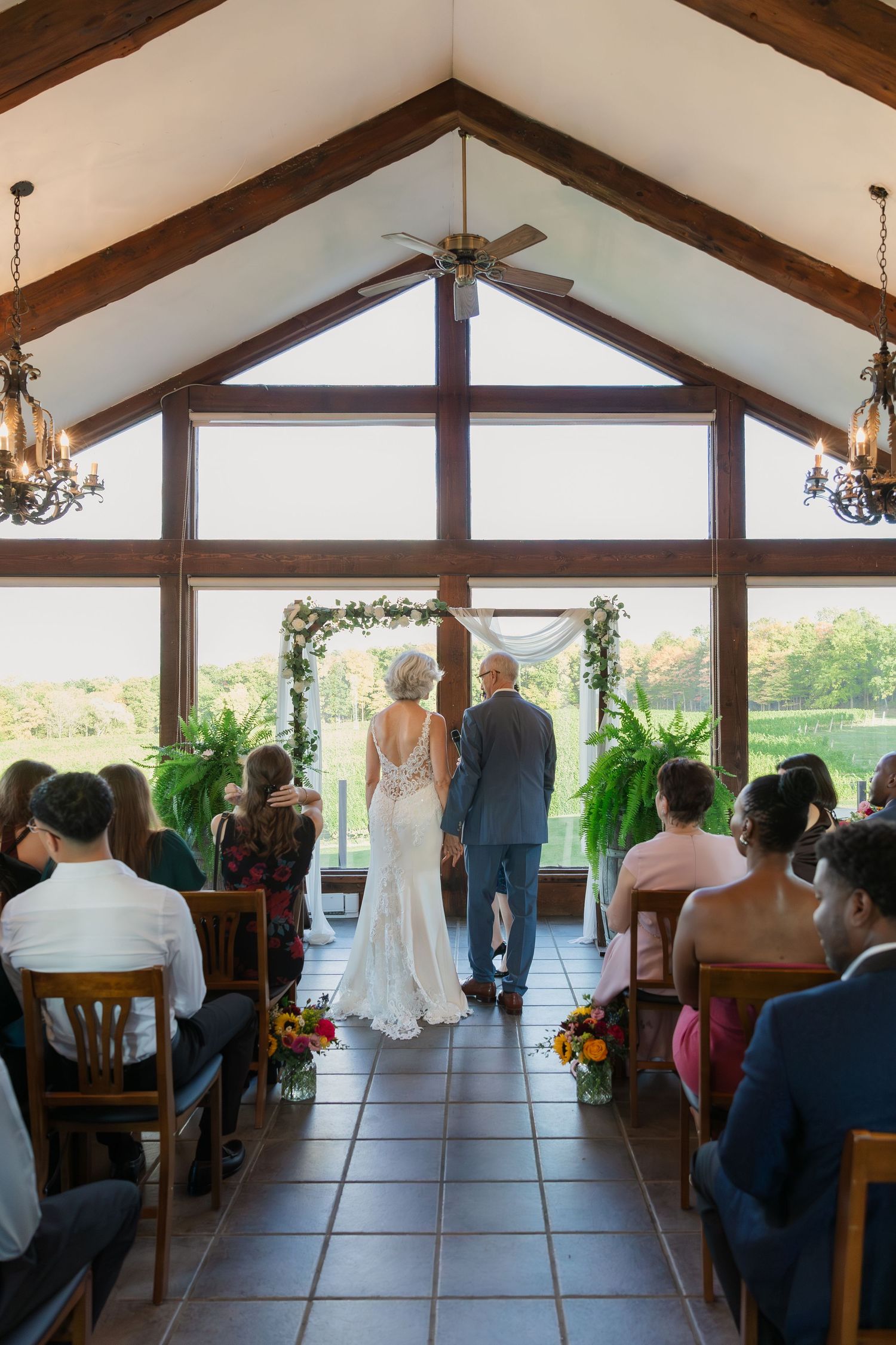 Bride and groom stand in front of alter in the Carriage House at Vineland Estates Winery.