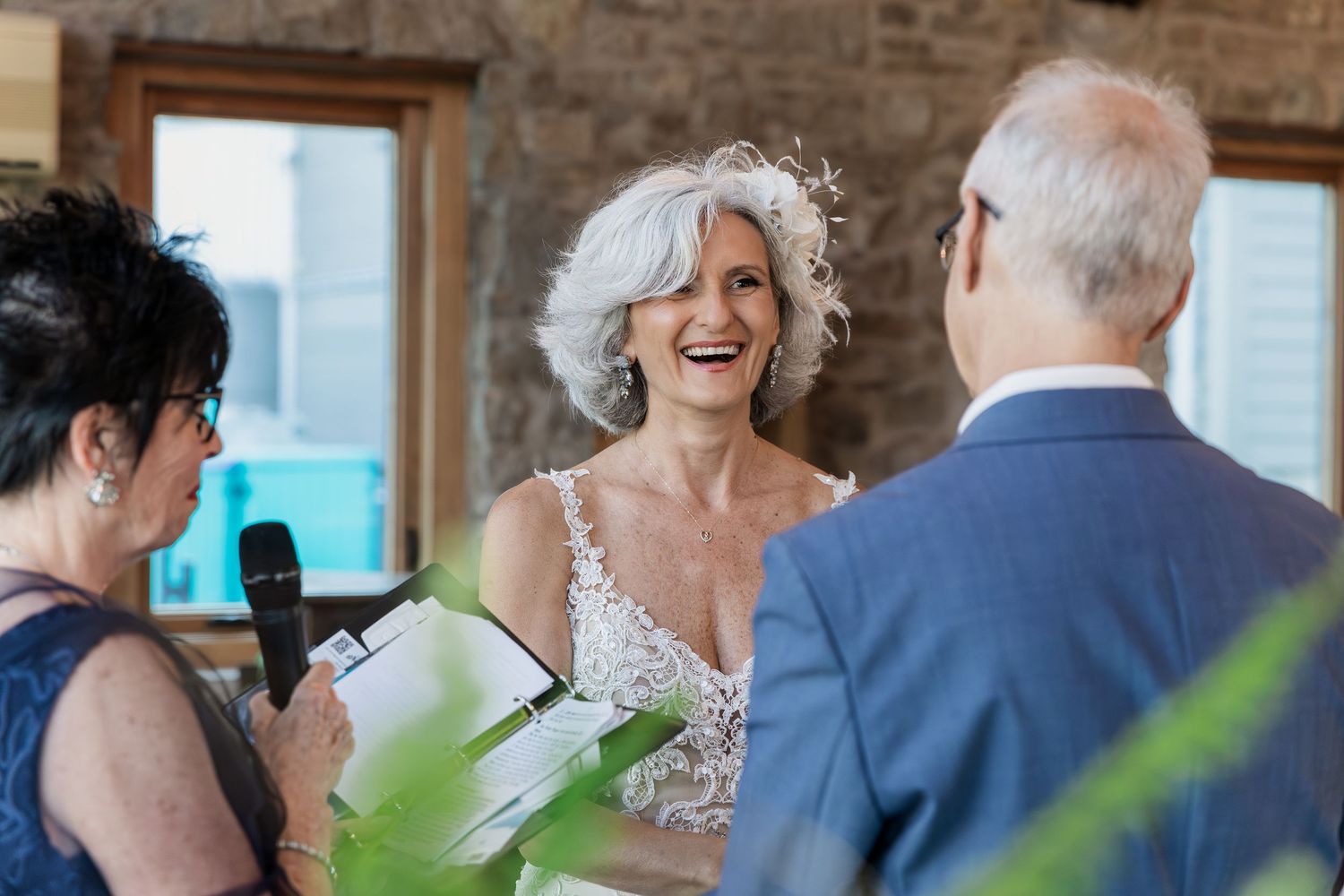 Bride laughs during her wedding ceremony in the Carriage House at Vineland Estates Winery.