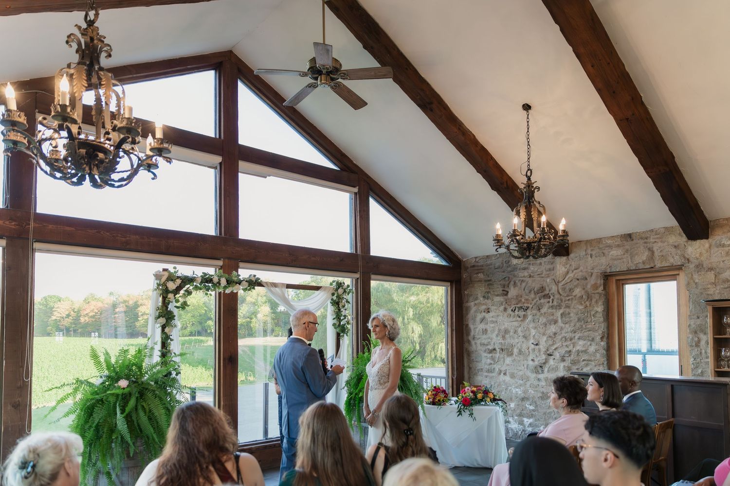 An intimate wedding ceremony takes place in the Carriage House at Vineland Estates Winery.