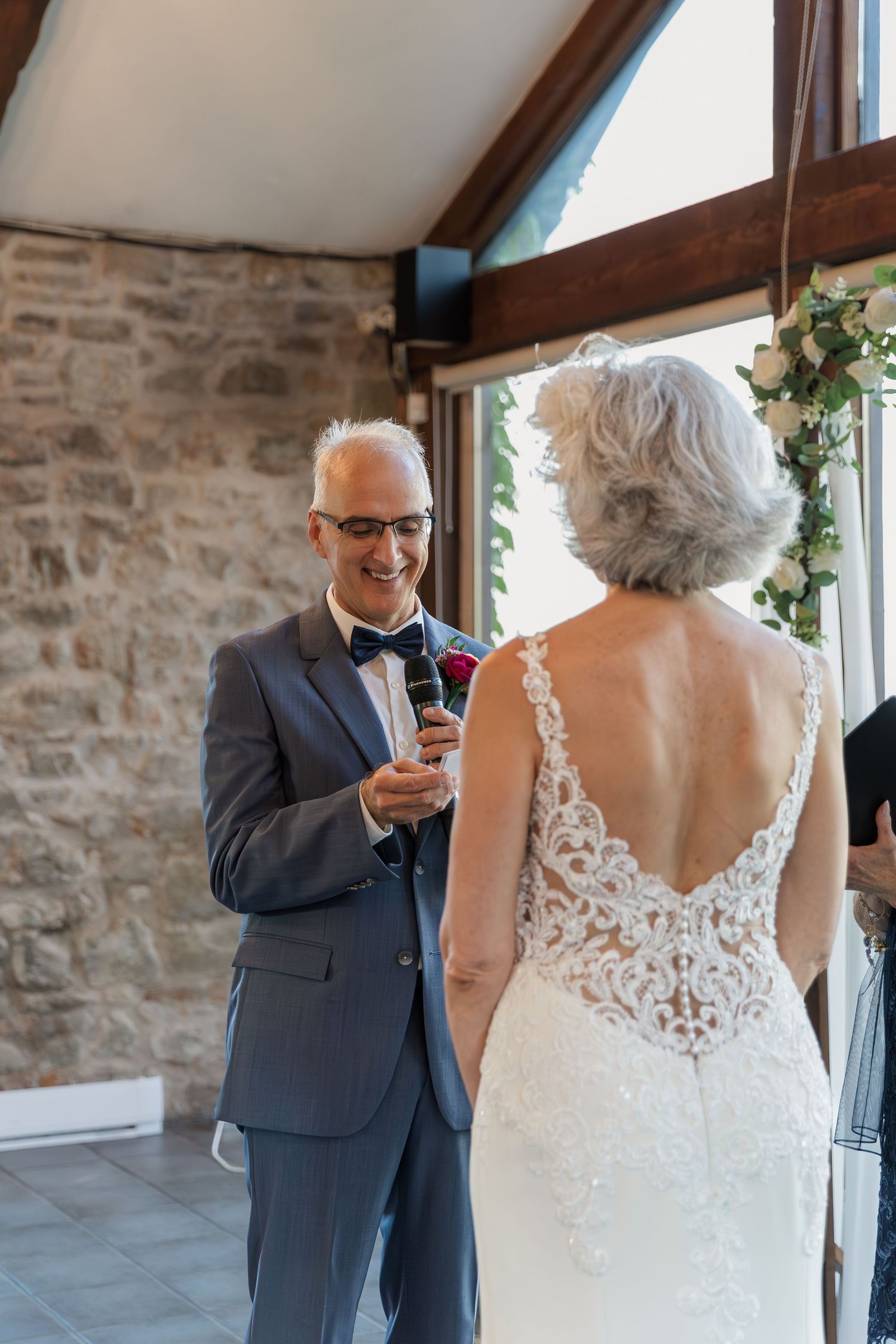 Groom reading his vows to his bride in the Carriage House at Vineland Estates Winery.