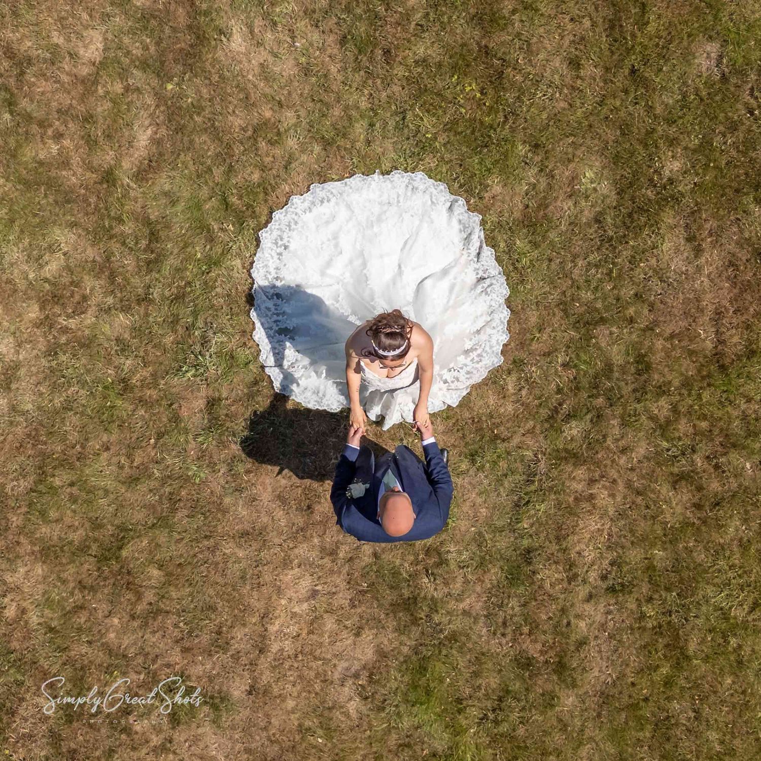 Aerial photograph of the bride and groom holding hands after their wedding at Coventry Registry Office