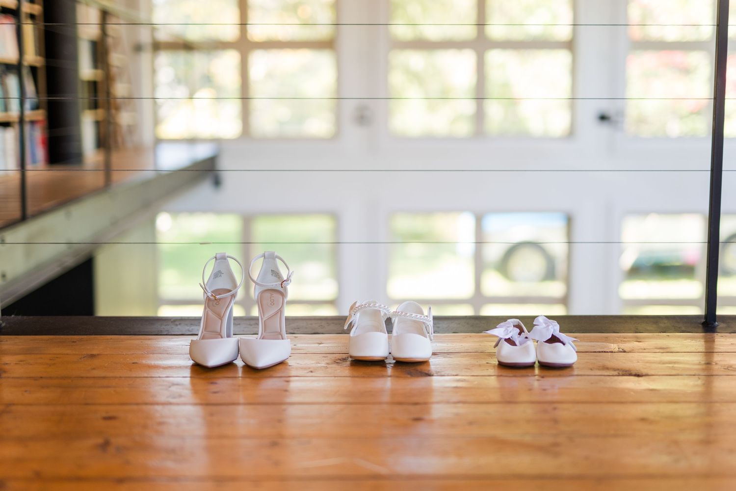 White sneakers and pants shown in progression walking across a wooden floor with sunlight streaming through windows.