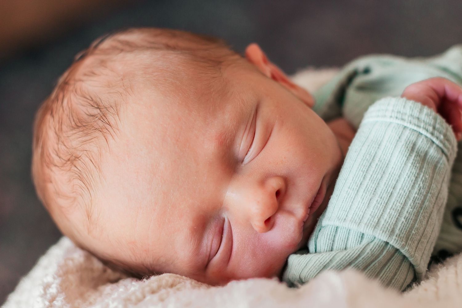 Peaceful newborn baby sleeping in a soft white blanket | Westminster, CO motherhood & family photographer