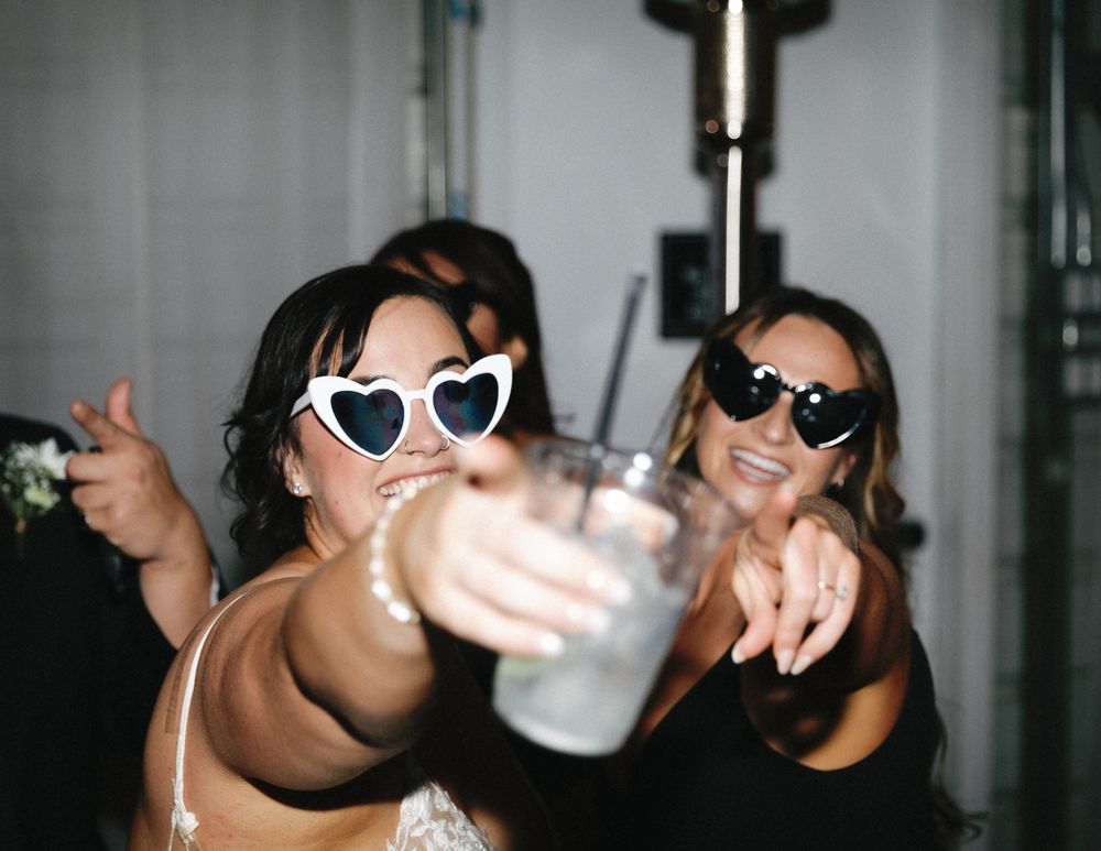 A bride and maid of honor celebrating the wedding reception after party on the dance floor in Vancouver, B.C.