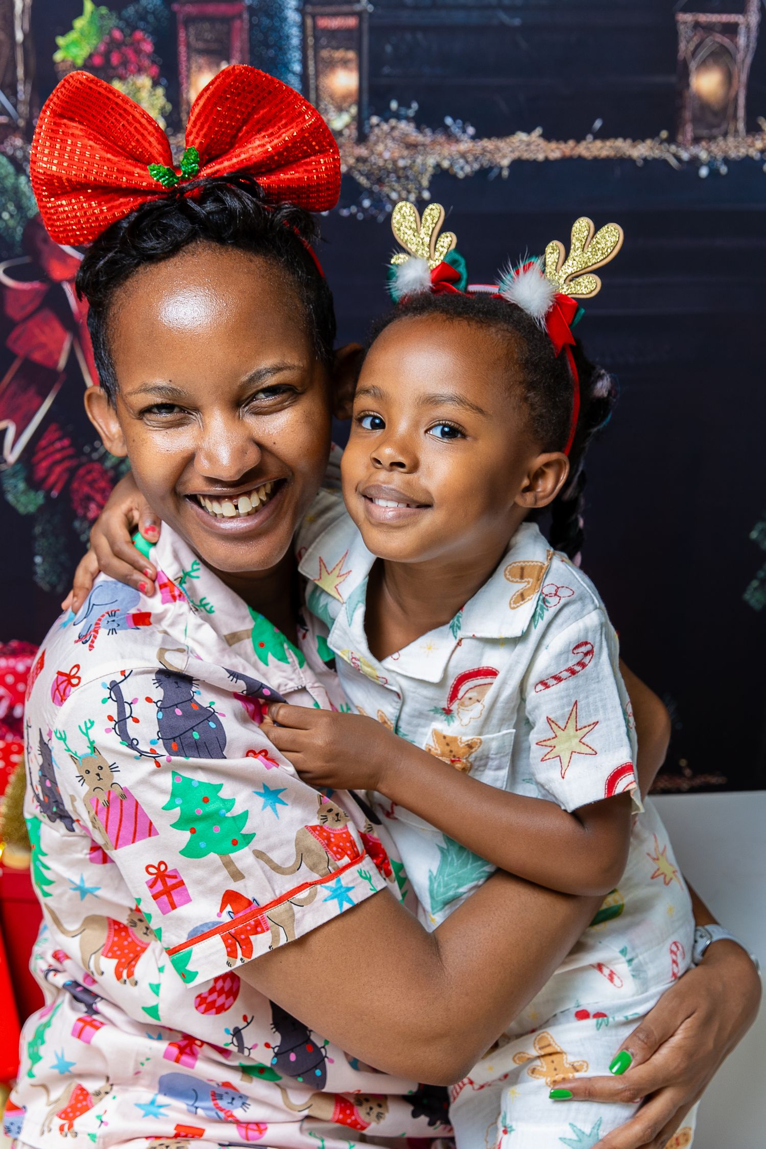 Festive holiday scene with matching Christmas outfits and red bows showing joyful embraces and smiles.