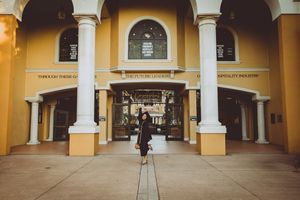 Panoramic view of a Spanish colonial style courtyard with yellow walls and white columns.