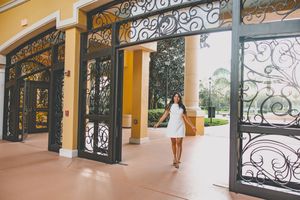 A series showing a walkway with decorative metal railings and yellow walls in a Mediterranean style building.