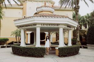 Luxury property entrance with Mediterranean architectural details and landscaping.