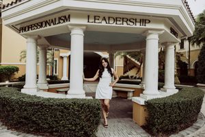 Architectural view of university building entrance with leadership signage and columns.