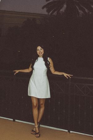 Playful nighttime poses on an outdoor balcony with railing.