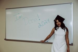 Clean whiteboard mounted on beige classroom wall with minimal markings.