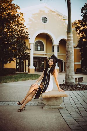A series of artistic poses against a Mediterranean-style building with arched columns and yellow walls.