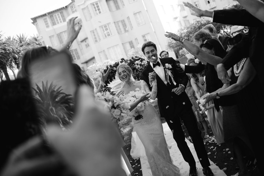 A black and white wedding celebration with guests dancing and enjoying themselves on the dance floor.