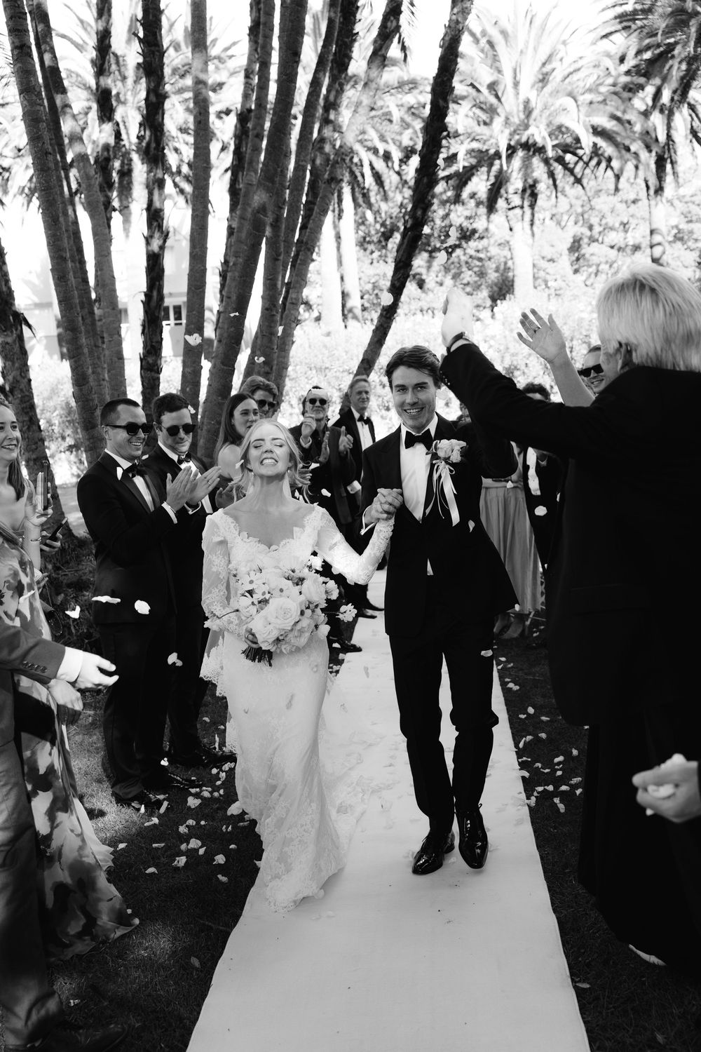 Black and white wedding ceremony photos showing guests celebrating with confetti in a wooded outdoor setting.