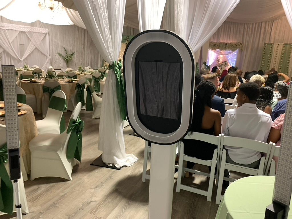 Wedding reception venue with white chair covers and elegant decor setup for a celebration.