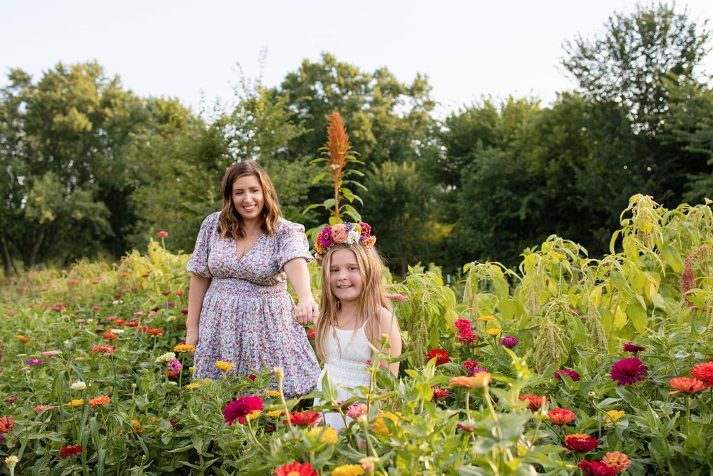 Mother and daughter walking among colorful flowers during summer mini sessions at First Roots Flower Farm in Oconomowoc, Wisconsin.