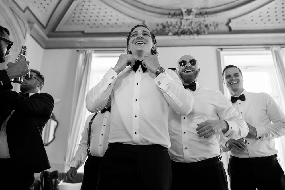 A black and white photo montage showing candid moments of people laughing and celebrating at a formal event.