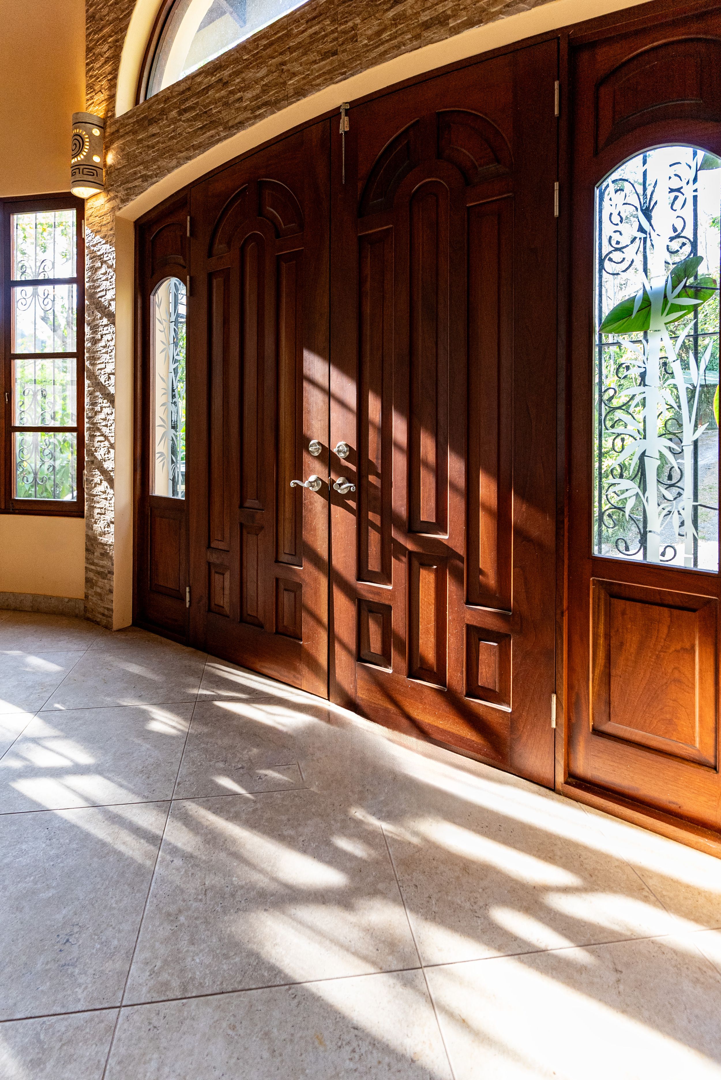 Entrance with carved wooden doors and classic architectural details