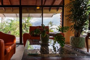 Living room with a rustic design and wooden details, connected to the terrace and garden