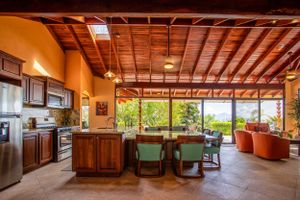 Kitchen with wooden finishes, ample natural lighting, and a garden view