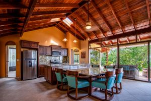 Kitchen with wooden finishes, ample natural lighting, and a garden view