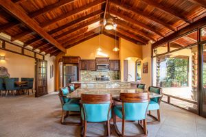 Living room with marble floors, wooden ceilings, and elegant furniture, with access to outdoor spaces
