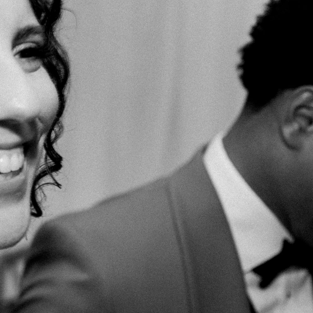 Black and white photo of two smiling people, with a soft focus creating an intimate candid moment.