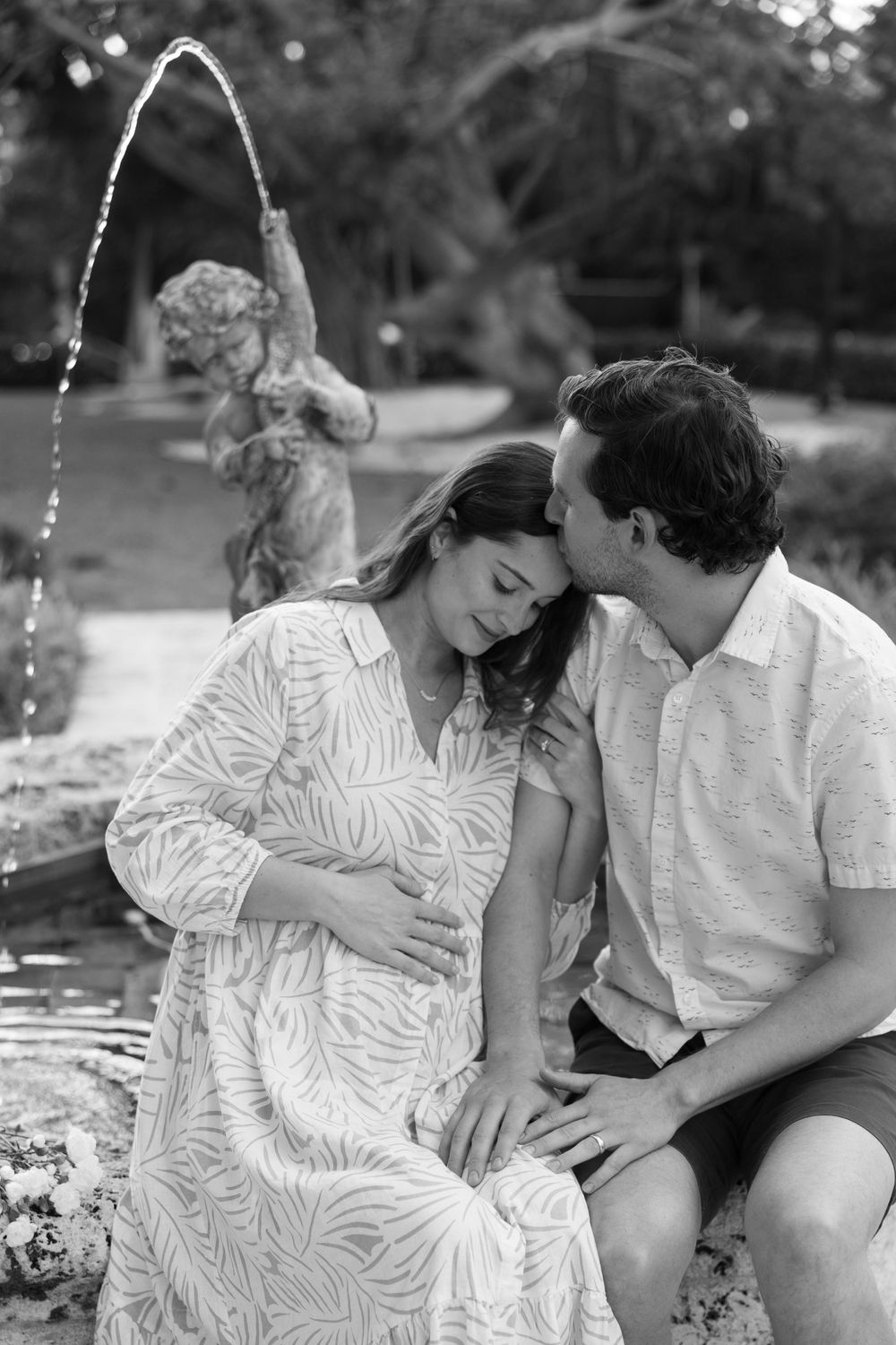 Golden Hour Maternity Session in Palm Beach, Florida captured by Lindsay McDow Photography featuring flowers, foliage, arches, and stairs