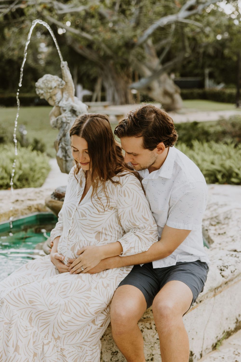 Golden Hour Maternity Session in Palm Beach, Florida captured by Lindsay McDow Photography featuring flowers, foliage, arches, and stairs