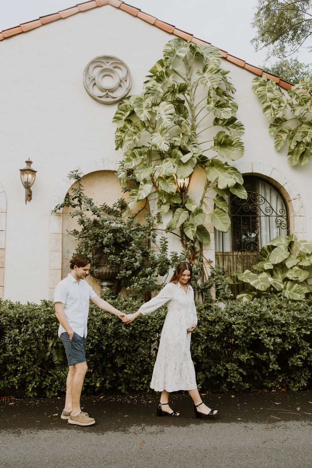 Golden Hour Maternity Session in Palm Beach, Florida captured by Lindsay McDow Photography featuring flowers, foliage, arches, and stairs