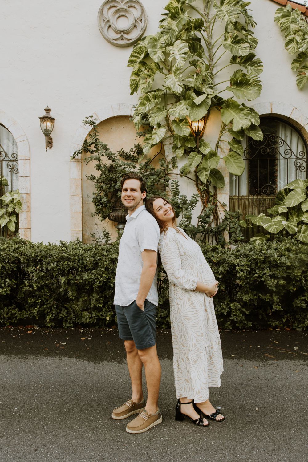 Golden Hour Maternity Session in Palm Beach, Florida captured by Lindsay McDow Photography featuring flowers, foliage, arches, and stairs