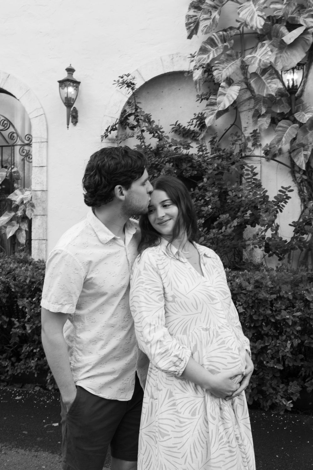 Golden Hour Maternity Session in Palm Beach, Florida captured by Lindsay McDow Photography featuring flowers, foliage, arches, and stairs