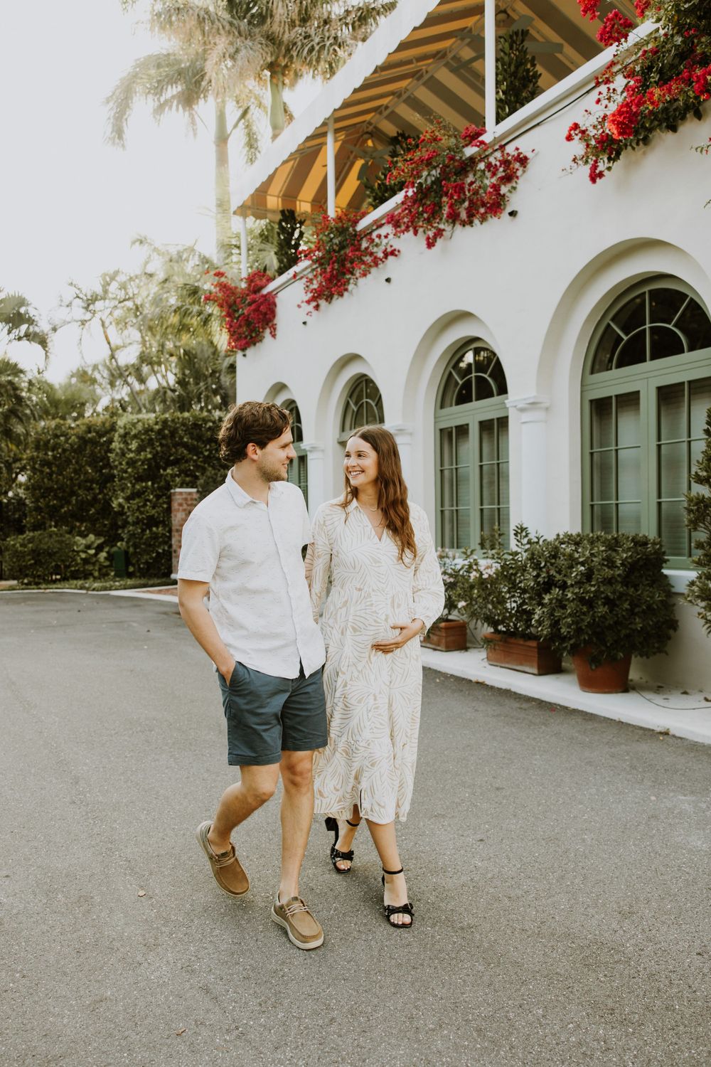 Golden Hour Maternity Session in Palm Beach, Florida captured by Lindsay McDow Photography featuring flowers, foliage, arches, and stairs