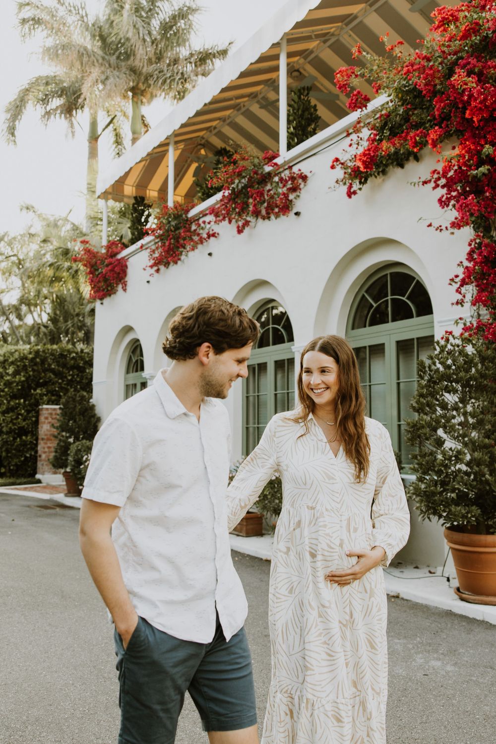 Golden Hour Maternity Session in Palm Beach, Florida captured by Lindsay McDow Photography featuring flowers, foliage, arches, and stairs