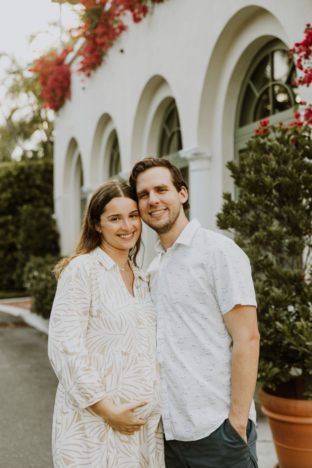 Golden Hour Maternity Session in Palm Beach, Florida captured by Lindsay McDow Photography featuring flowers, foliage, arches, and stairs