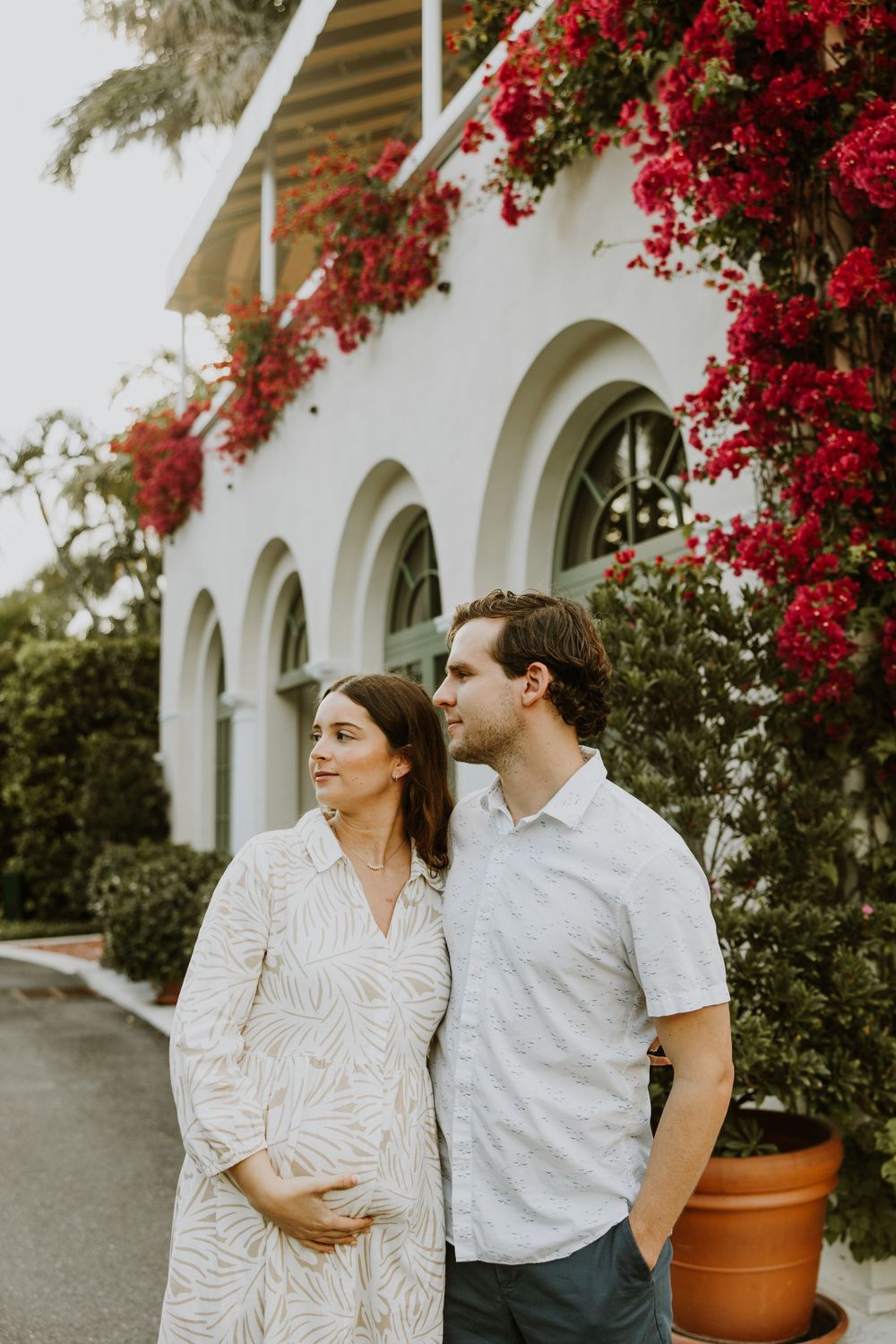 Golden Hour Maternity Session in Palm Beach, Florida captured by Lindsay McDow Photography featuring flowers, foliage, arches, and stairs