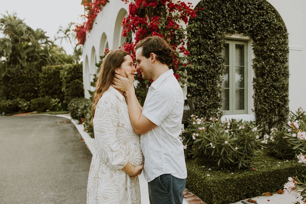 Golden Hour Maternity Session in Palm Beach, Florida captured by Lindsay McDow Photography featuring flowers, foliage, arches, and stairs