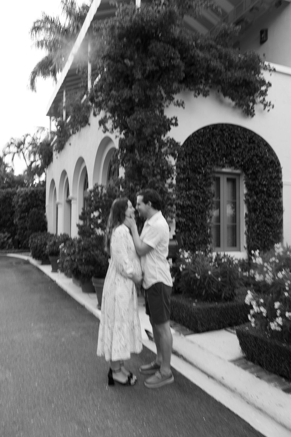 Golden Hour Maternity Session in Palm Beach, Florida captured by Lindsay McDow Photography featuring flowers, foliage, arches, and stairs