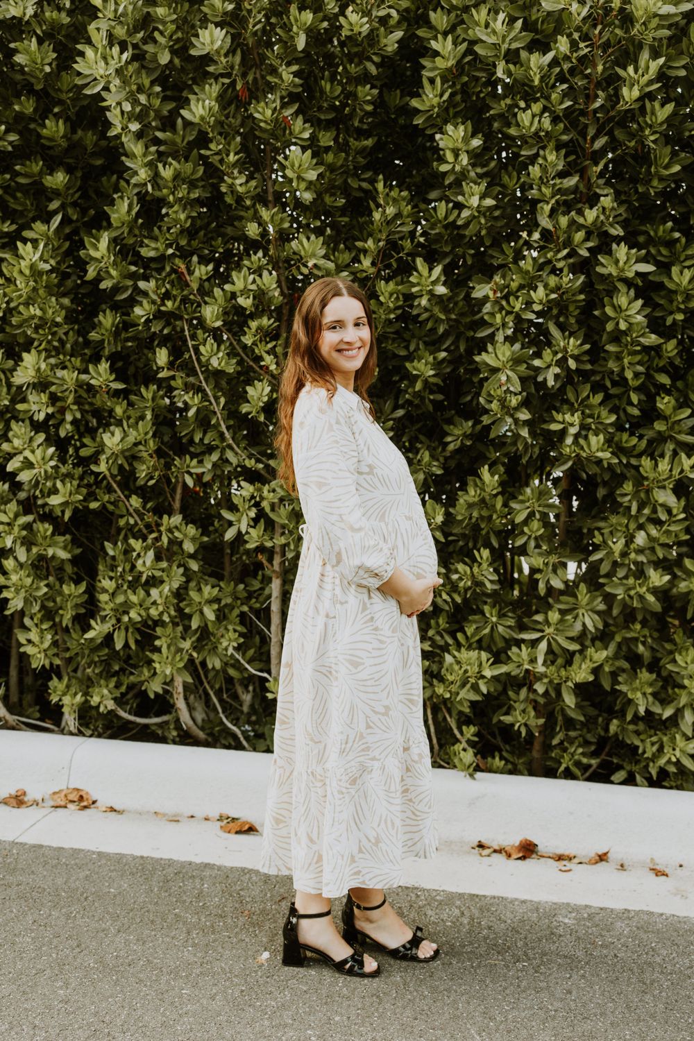 Golden Hour Maternity Session in Palm Beach, Florida captured by Lindsay McDow Photography featuring flowers, foliage, arches, and stairs
