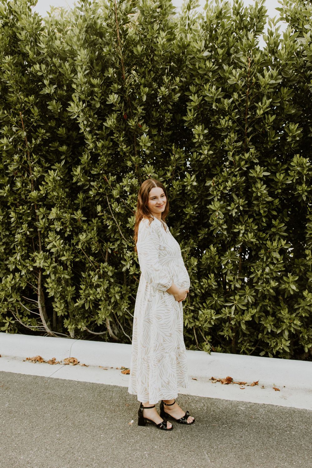 Golden Hour Maternity Session in Palm Beach, Florida captured by Lindsay McDow Photography featuring flowers, foliage, arches, and stairs