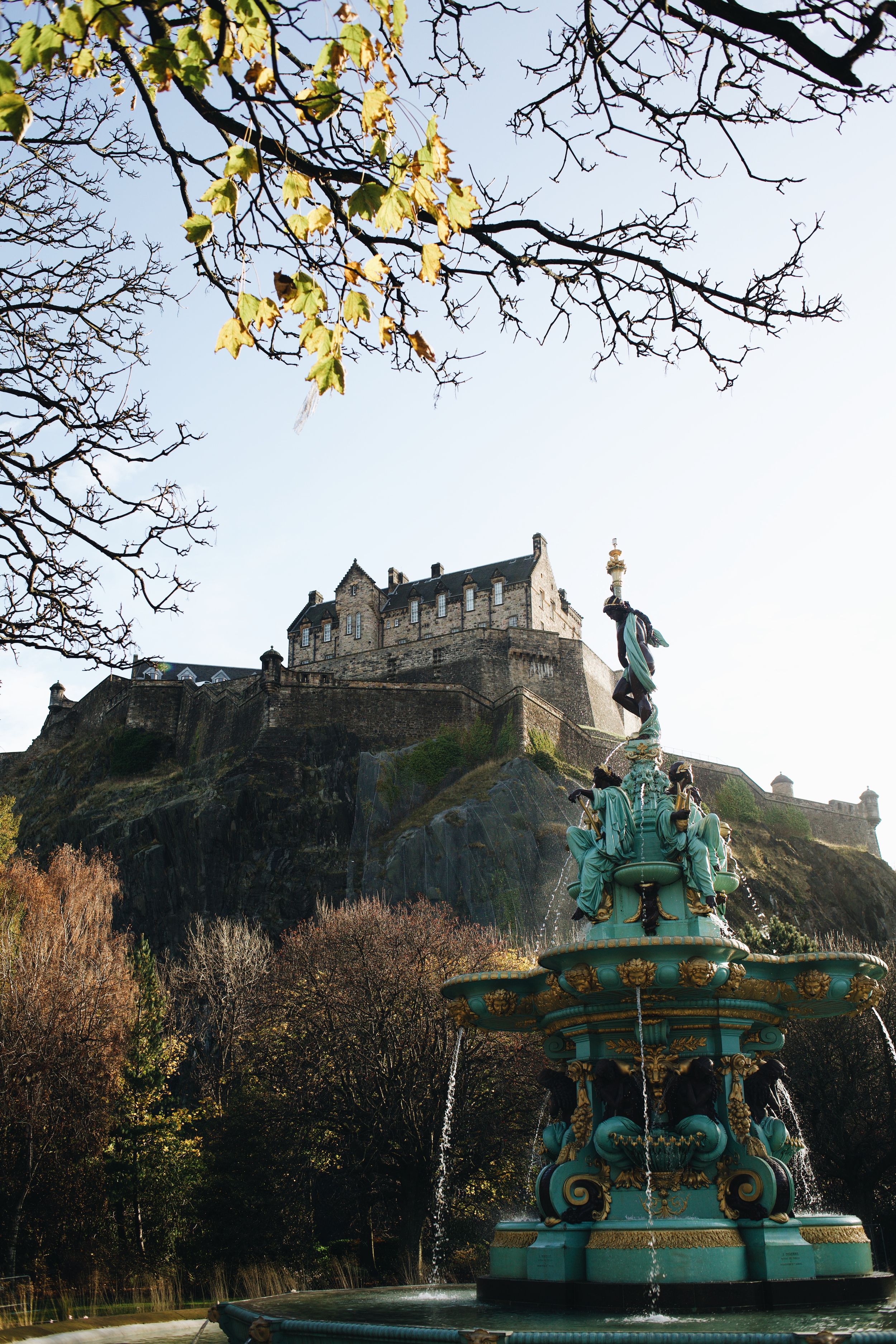 The Ross Fountain stands in Princes Street Gardens with Edinburgh Castle perched dramatically on the hilltop above.