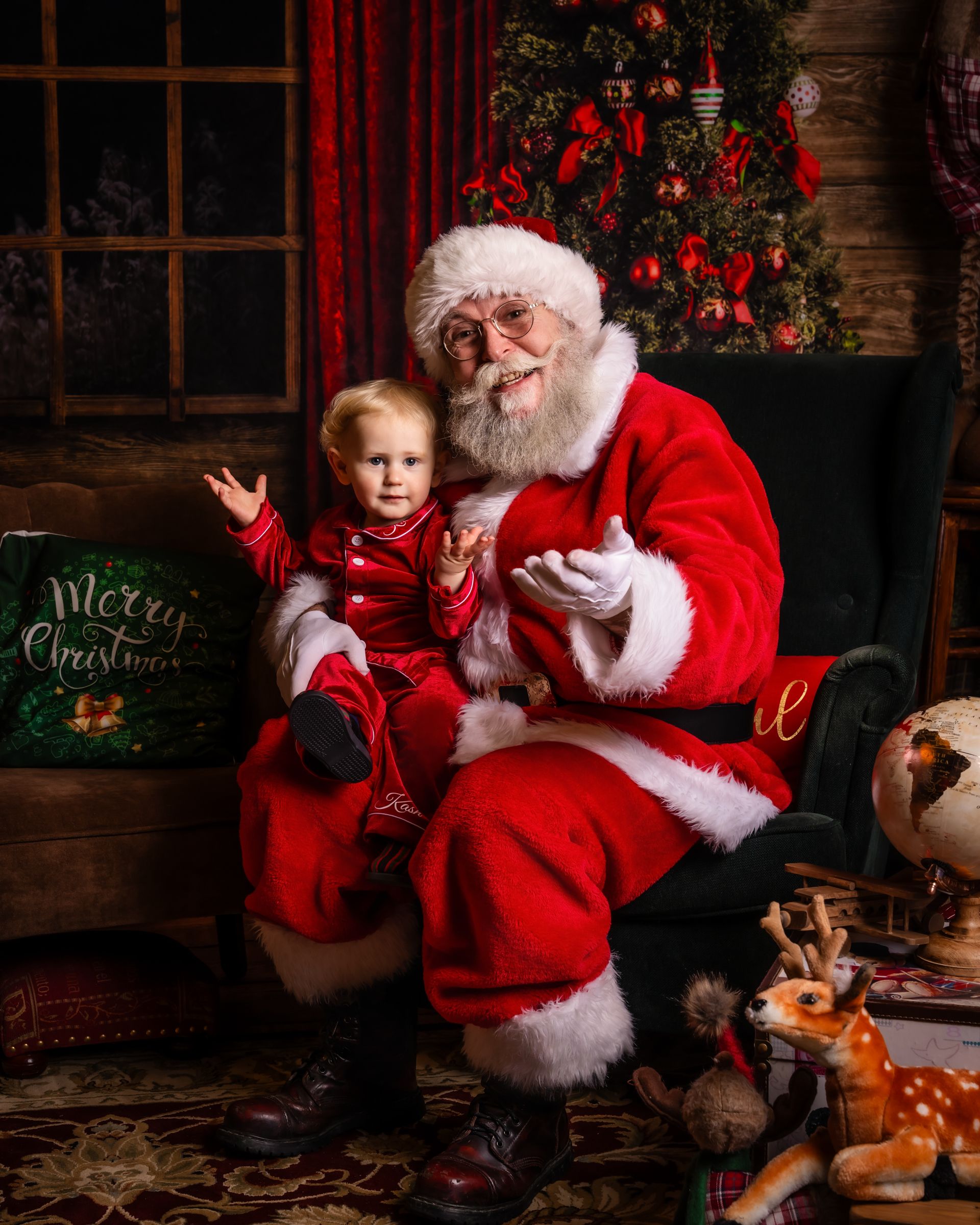 Santa Claus shares a magical moment in his chair by a decorated Christmas tree.