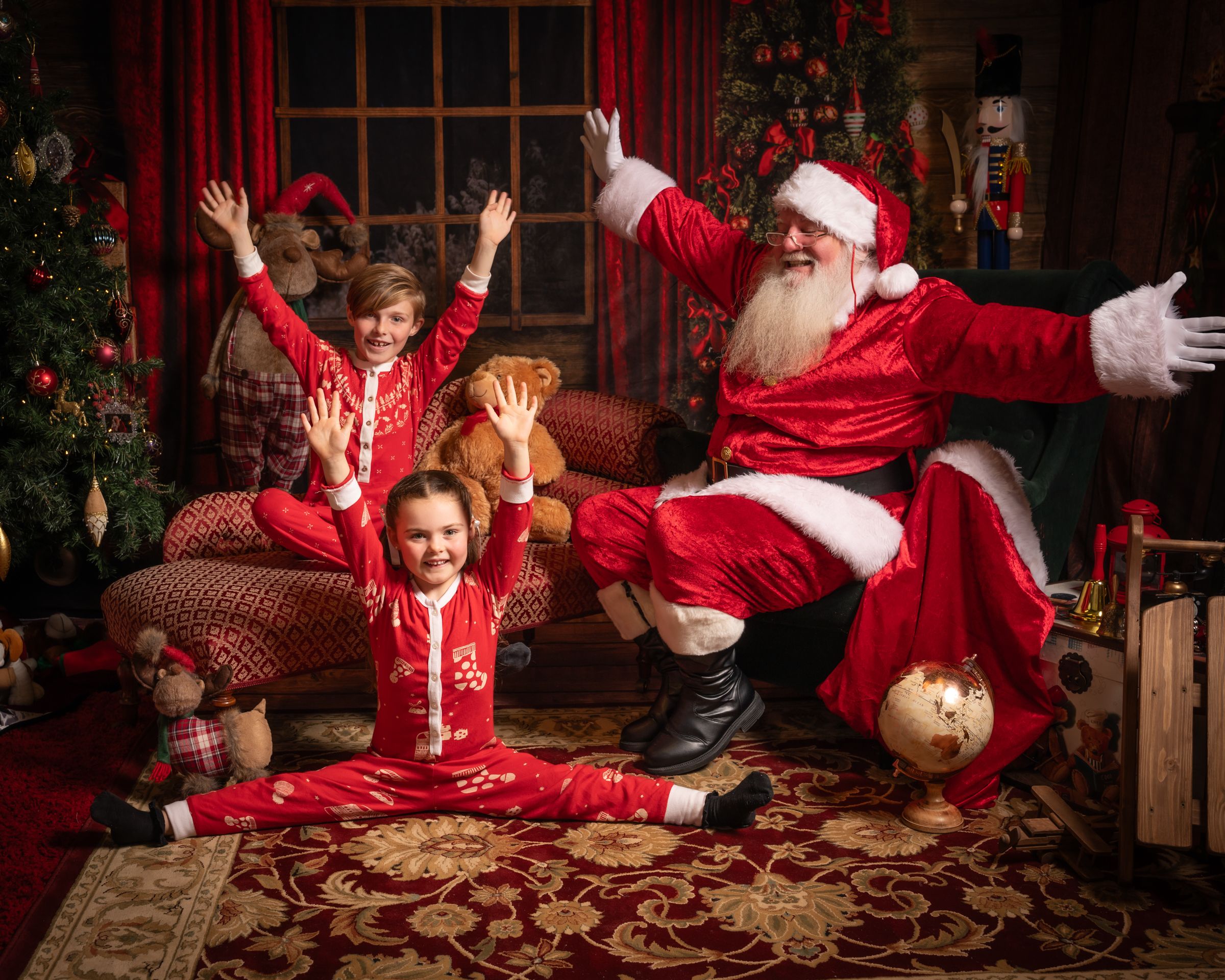 Festive holiday scene with Christmas tree and decorations in red and gold themed room.