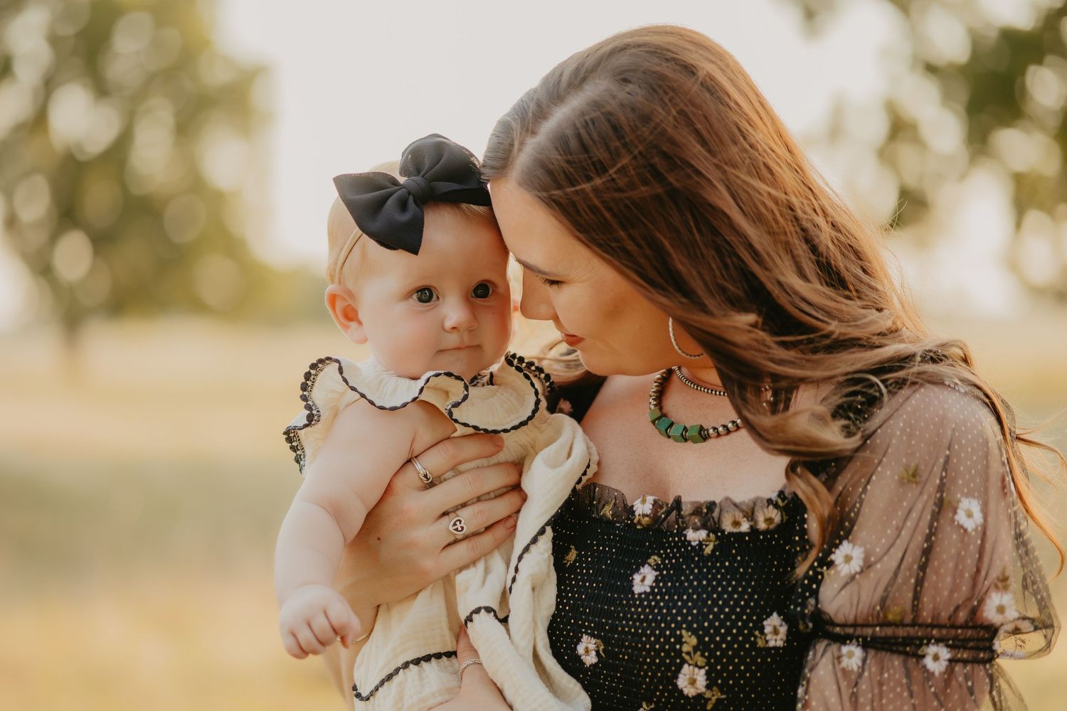 Candid family moments captured in golden sunlight during outdoor photo session.