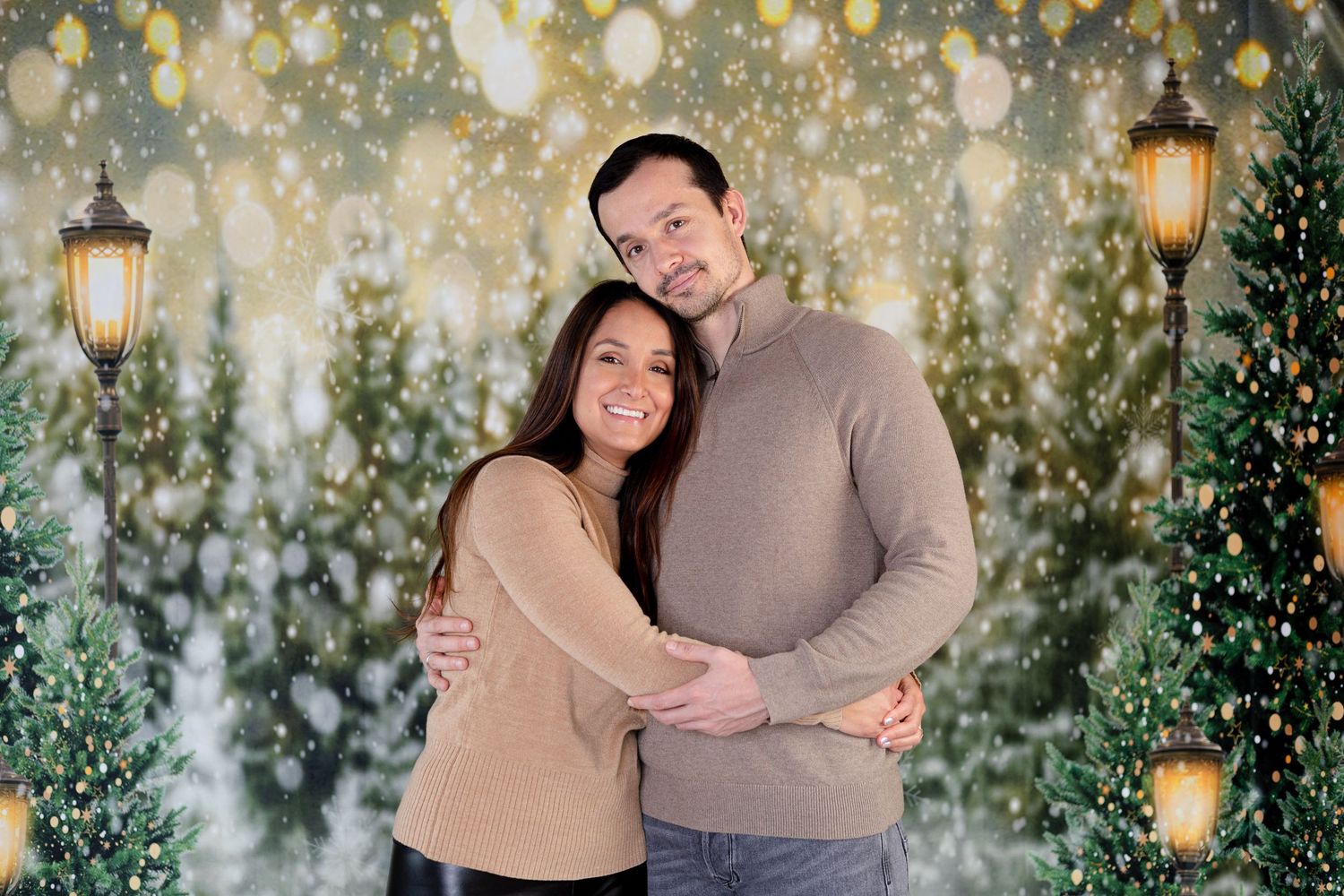 Romantic winter portrait session with twinkle lights and lanterns in background.