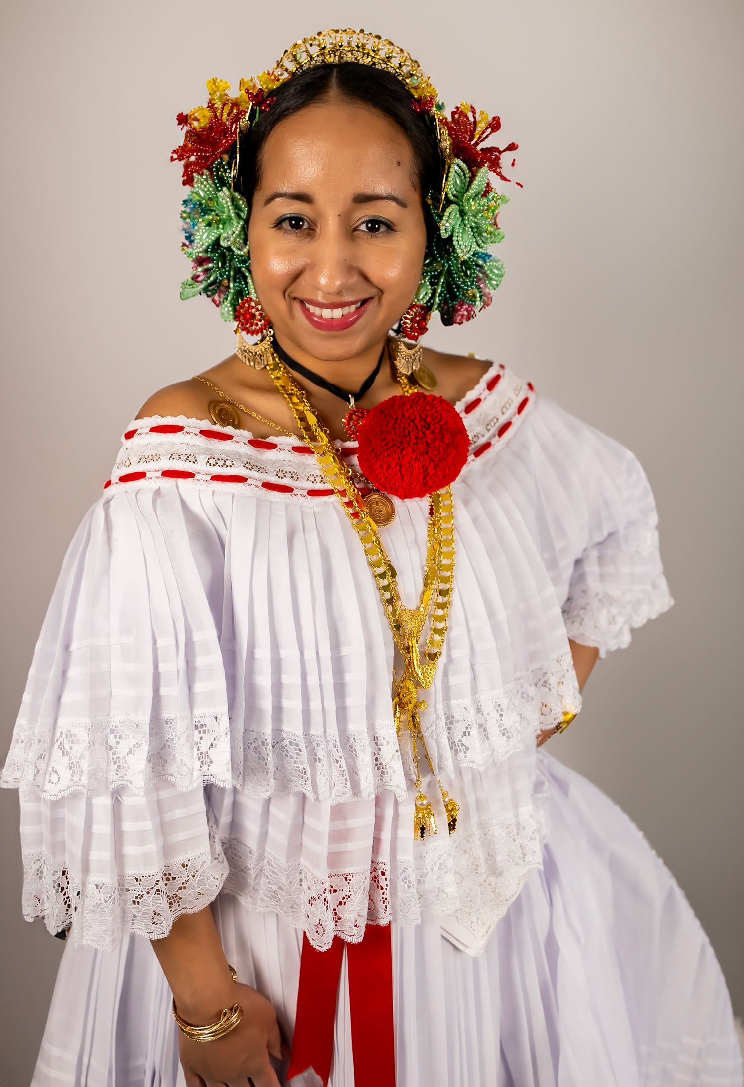Traditional Panamanian pollera dress with lace details and floral headpiece shown in sequence of poses.