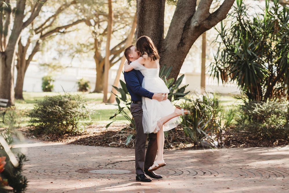 Engaged couple sharing a quiet moment during a sunrise session at The Henry B. Plant Museum in Tampa