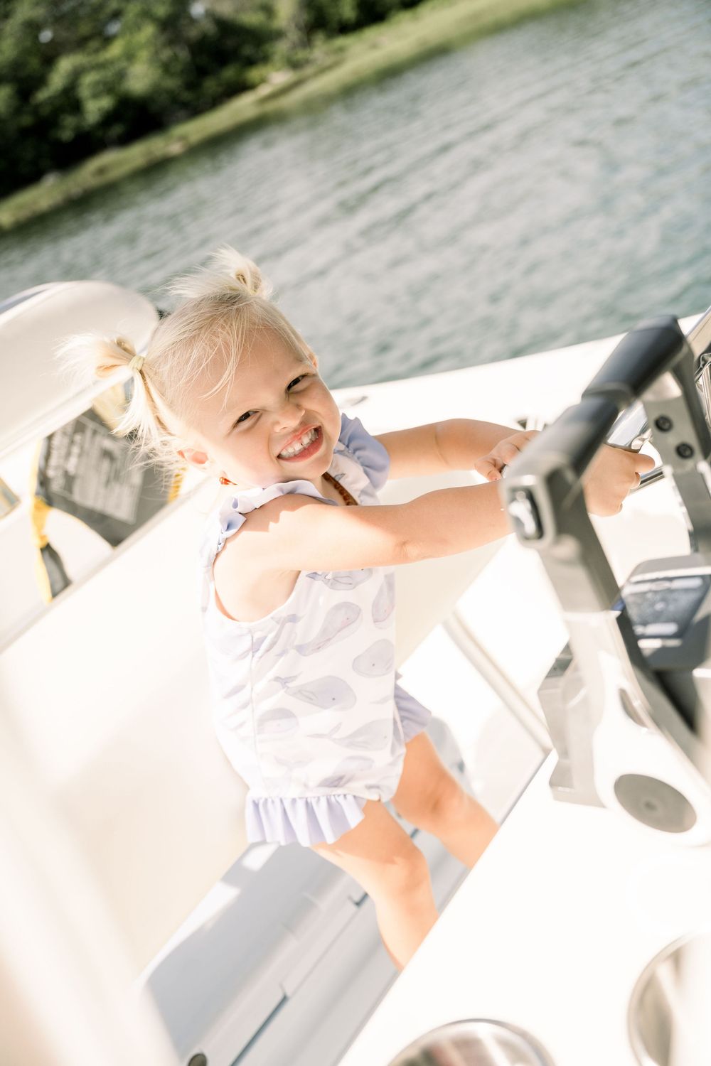 A sequence of joyful moments captured by a lake with sunlit reflections on the water.