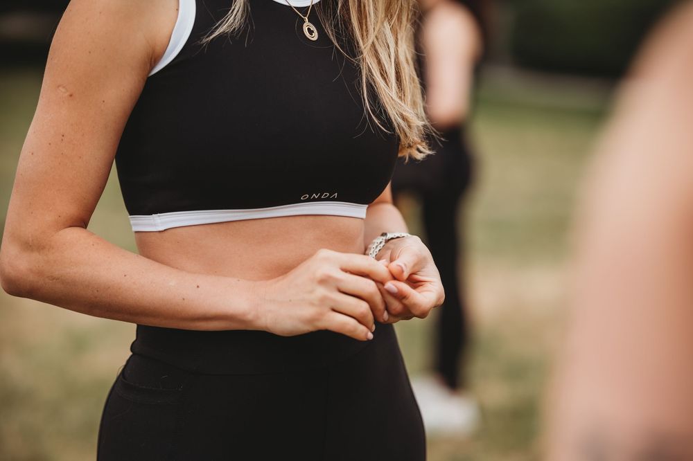 Close-up detail of athletic wear during outdoor group fitness session.
