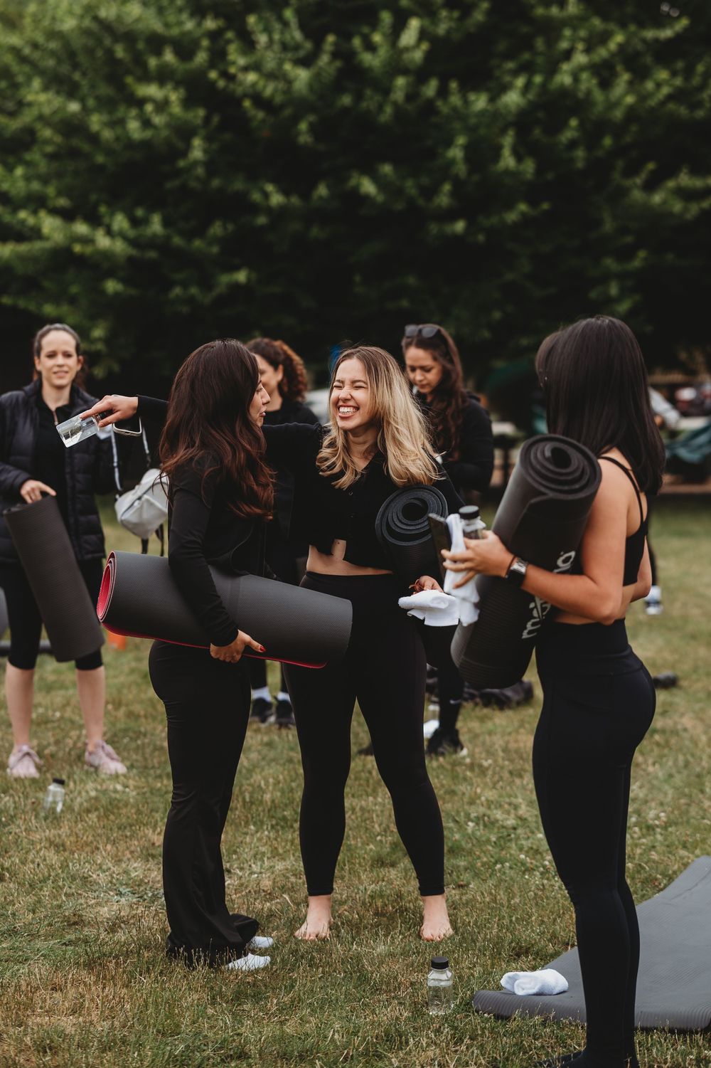 Group stretching and warming up before outdoor fitness class.